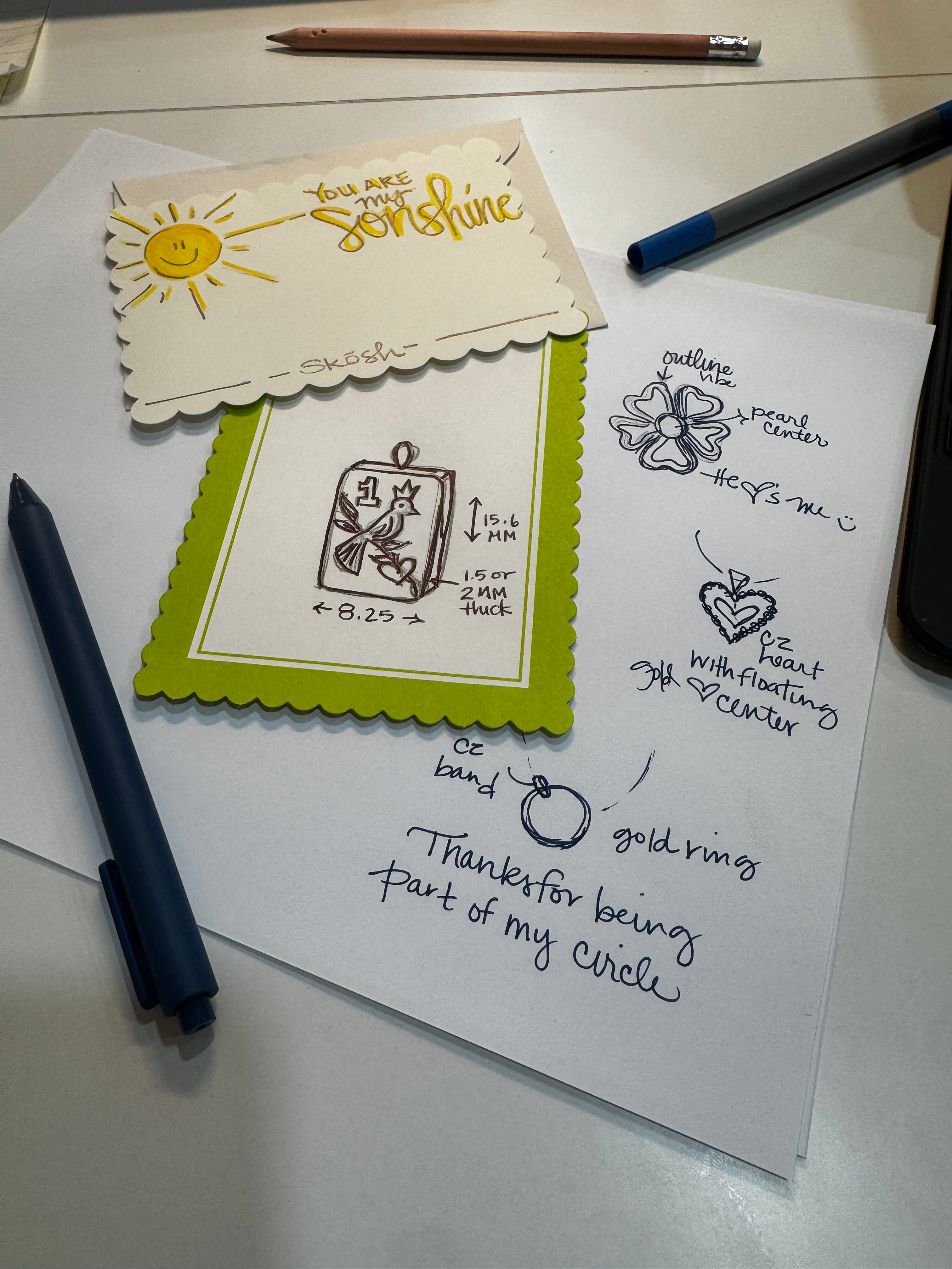 Hand-drawn jewelry design sketches with pens